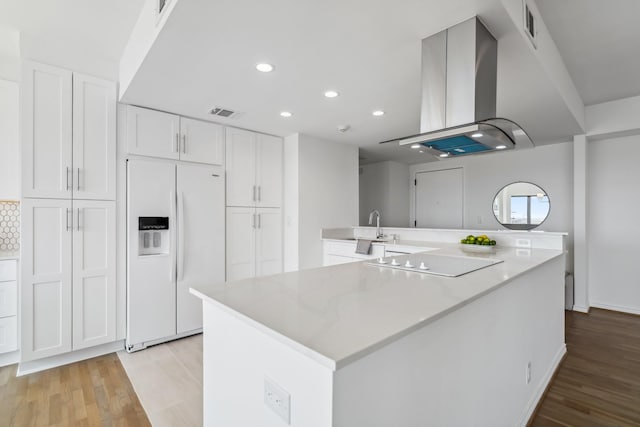 2001 Holcombe Blvd Unit 2305, Houston, TX 77030 - kitchen featuring white refrigerator with ice dispenser, electric cooktop, range hood, white cabinets, and recessed lighting