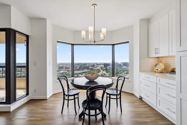 2001 Holcombe Blvd Unit 2305, Houston, TX 77030 - dining space with light wood-type flooring and a chandelier