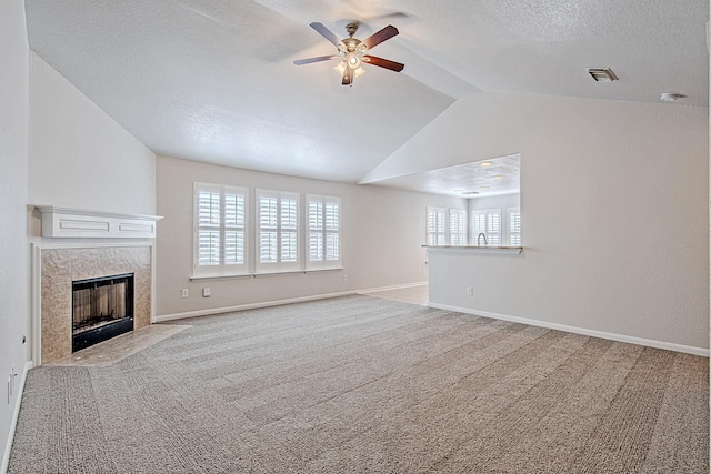 9614 Summer Laurel Ln, Houston, TX 77088 - unfurnished living room with a ceiling fan, a premium fireplace, vaulted ceiling, carpet flooring, and a textured ceiling