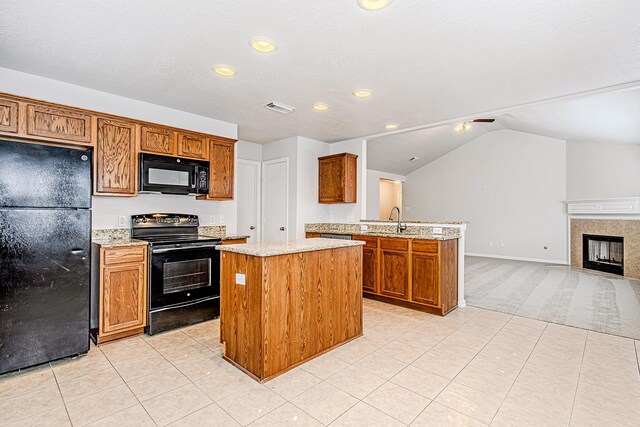 9614 Summer Laurel Ln, Houston, TX 77088 - kitchen with black appliances, a peninsula, light carpet, open floor plan, and brown cabinets