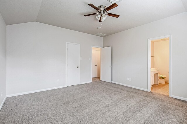 9614 Summer Laurel Ln, Houston, TX 77088 - unfurnished bedroom with light colored carpet, lofted ceiling, ensuite bathroom, and ceiling fan