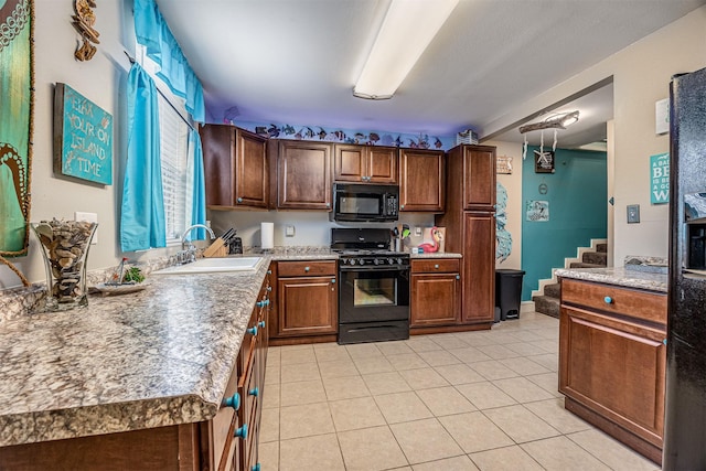 1315 40th St, Rear, Galveston, TX 77550 - kitchen featuring black appliances, light tile patterned floors, and light countertops
