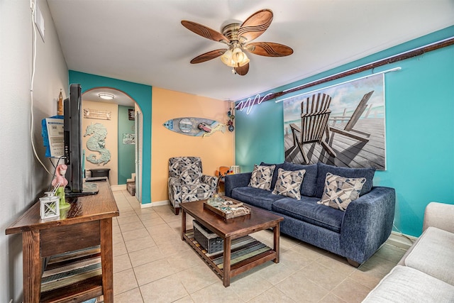 1315 40th St, Rear, Galveston, TX 77550 - living area with arched walkways, ceiling fan, and light tile patterned floors