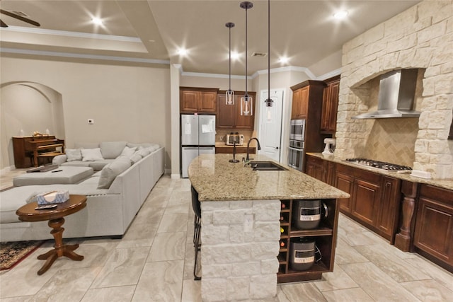 31428 Longwood Park Ln, Spring, TX 77386 - kitchen with appliances with stainless steel finishes, wall chimney range hood, ornamental molding, open shelves, and light stone countertops