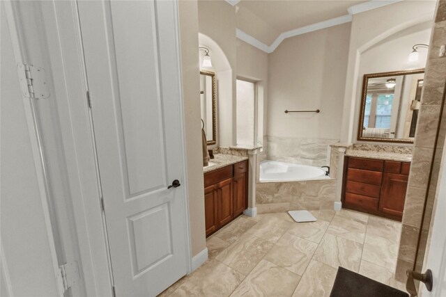 31428 Longwood Park Ln, Spring, TX 77386 - bathroom with two vanities, a garden tub, ornamental molding, and marble look tile flooring