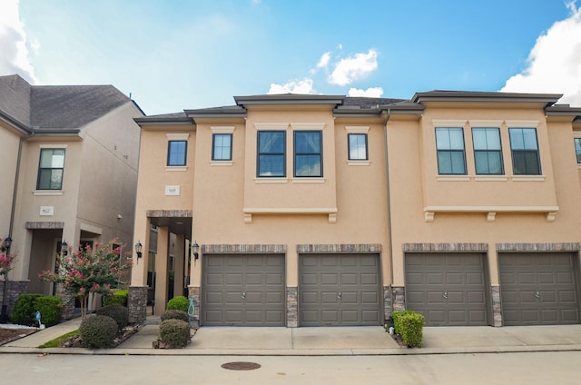 11611 Royal Oaks Vw, Houston, TX 77082 - view of property with a garage, stucco siding, driveway, and stone siding