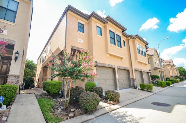 11611 Royal Oaks Vw, Houston, TX 77082 - view of building exterior with a residential view, a garage, and driveway