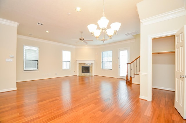 11611 Royal Oaks Vw, Houston, TX 77082 - unfurnished living room featuring a chandelier, crown molding, stairs, light wood-type flooring, and a fireplace