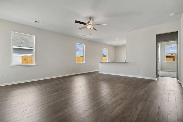16434 Blossom Grove Dr, Conroe, TX 77303 - unfurnished living room featuring a ceiling fan and dark wood-style floors