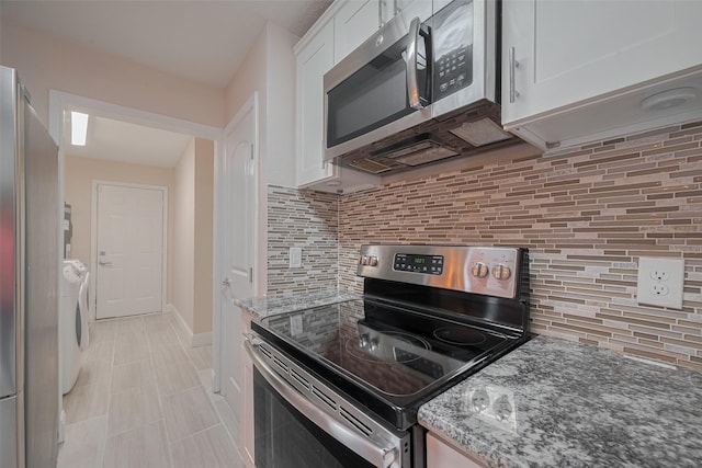 3930 Daphne St, Houston, TX 77021 - kitchen with appliances with stainless steel finishes, white cabinets, independent washer and dryer, stone counters, and backsplash