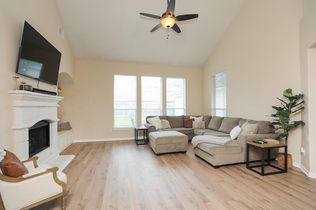 15802 Aberdeen Trails Dr, Houston, TX 77095 - living room featuring light wood-type flooring, a fireplace with raised hearth, high vaulted ceiling, and a ceiling fan