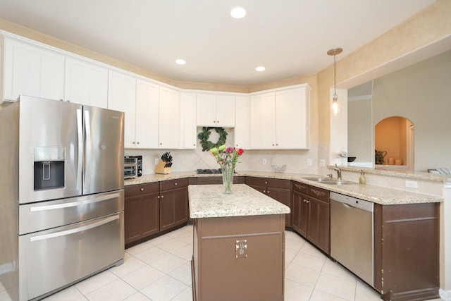 15802 Aberdeen Trails Dr, Houston, TX 77095 - kitchen featuring appliances with stainless steel finishes, light tile patterned flooring, white cabinetry, hanging light fixtures, and a center island