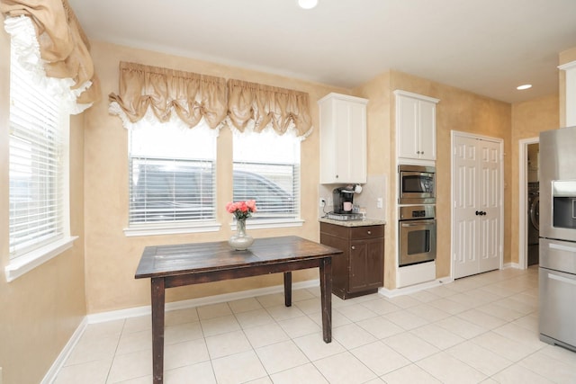 15802 Aberdeen Trails Dr, Houston, TX 77095 - kitchen with appliances with stainless steel finishes, white cabinetry, light tile patterned floors, recessed lighting, and light stone countertops