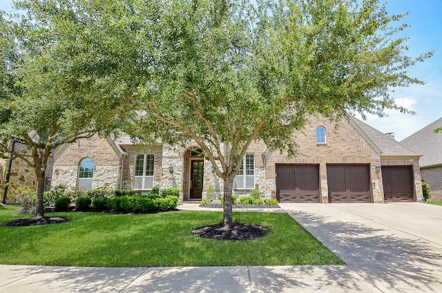 27522 Blackstone Canyon Ln, Katy, TX 77494 - view of front facade featuring driveway, a front yard, brick siding, and an attached garage
