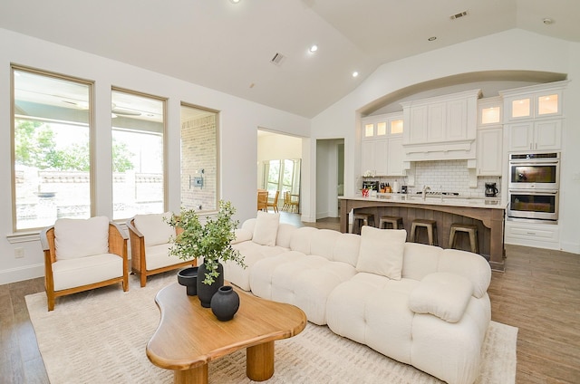 27522 Blackstone Canyon Ln, Katy, TX 77494 - living room featuring vaulted ceiling, wood finished floors, and recessed lighting