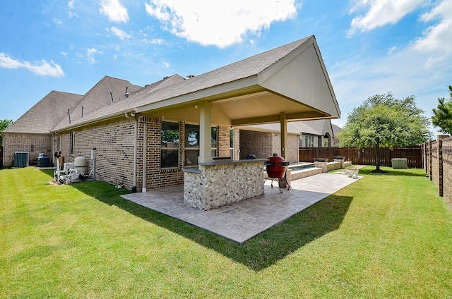 27522 Blackstone Canyon Ln, Katy, TX 77494 - back of property featuring a patio, brick siding, a fenced backyard, and roof with shingles
