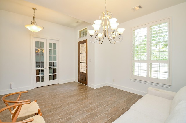 27522 Blackstone Canyon Ln, Katy, TX 77494 - living area with french doors, wood finished floors, and a chandelier
