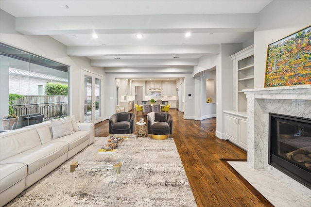 8304 Maple Ct, Bellaire, TX 77401 - living area featuring a high end fireplace, dark wood-style flooring, recessed lighting, french doors, and built in features