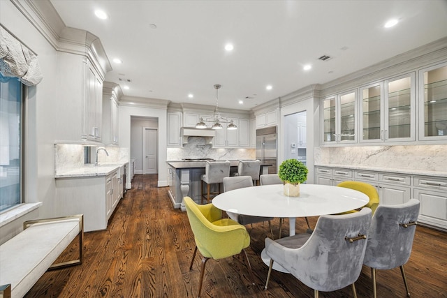 8304 Maple Ct, Bellaire, TX 77401 - dining area with crown molding, recessed lighting, and dark wood-style flooring