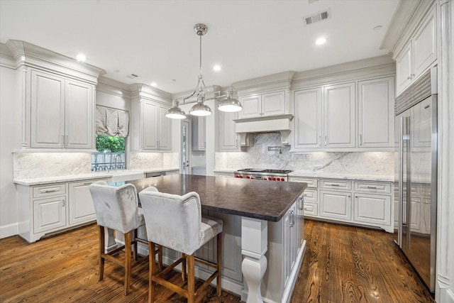 8304 Maple Ct, Bellaire, TX 77401 - kitchen with built in fridge, dark wood-style floors, white cabinets, backsplash, and recessed lighting
