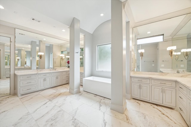 8304 Maple Ct, Bellaire, TX 77401 - full bathroom with a soaking tub, two vanities, marble finish floors, lofted ceiling, and a chandelier