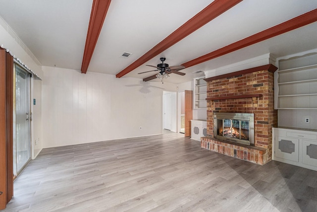 14030 Duncannon Dr, Houston, TX 77015 - unfurnished living room with wood finished floors, beamed ceiling, ceiling fan, and a fireplace