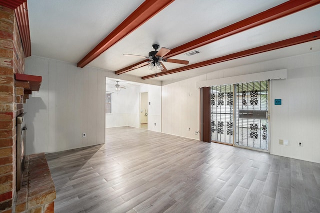 14030 Duncannon Dr, Houston, TX 77015 - unfurnished living room featuring ceiling fan, a fireplace, beamed ceiling, and wood finished floors