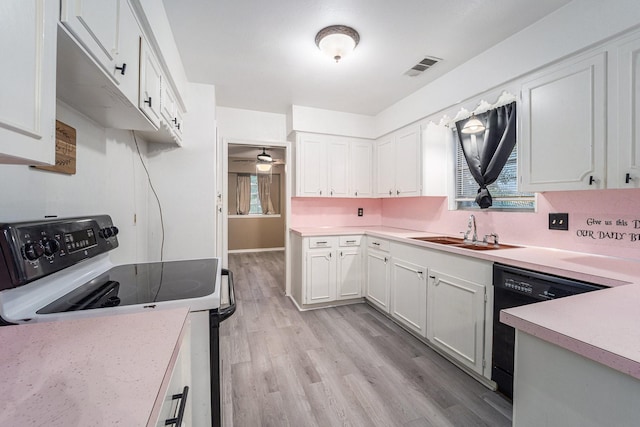 14030 Duncannon Dr, Houston, TX 77015 - kitchen featuring electric range, black dishwasher, light countertops, light wood-style floors, and white cabinets