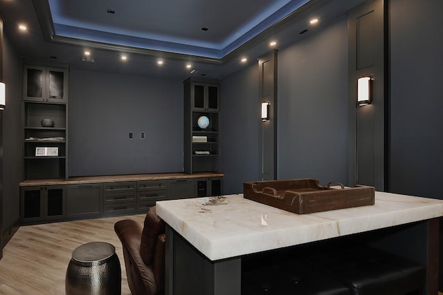 27003 Hidden Grove Landing Dr, Spring, TX 77386 - home theater room featuring light wood-style flooring, recessed lighting, and a tray ceiling