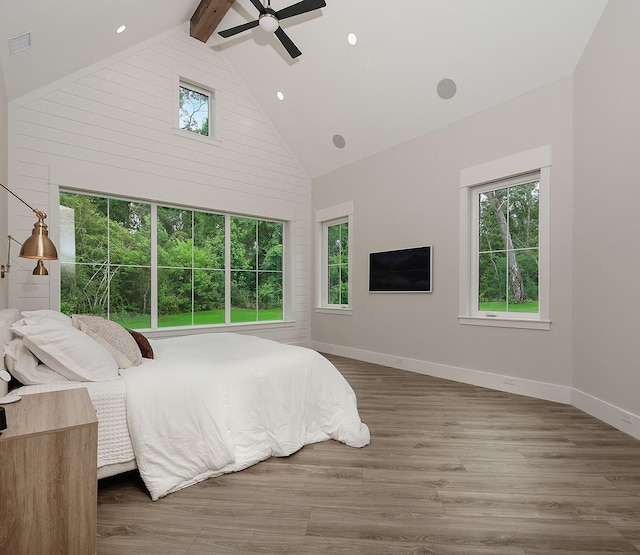 27003 Hidden Grove Landing Dr, Spring, TX 77386 - bedroom with multiple windows, high vaulted ceiling, beamed ceiling, ceiling fan, and wood finished floors