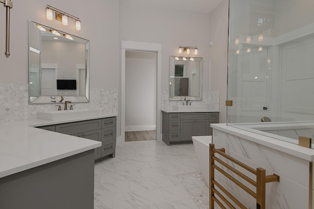 27003 Hidden Grove Landing Dr, Spring, TX 77386 - full bath featuring marble look tile flooring, two vanities, backsplash, an enclosed shower, and a freestanding tub