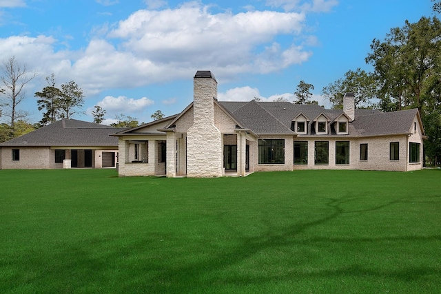 27003 Hidden Grove Landing Dr, Spring, TX 77386 - back of property with a chimney, a lawn, and brick siding