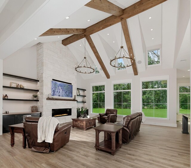 27003 Hidden Grove Landing Dr, Spring, TX 77386 - living area with a chandelier, high vaulted ceiling, beamed ceiling, light wood-style floors, and a fireplace