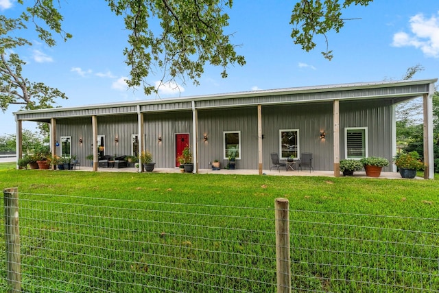 43 Windmill Dr, Hempstead, TX 77445 - back of house featuring board and batten siding, a yard, and a patio area