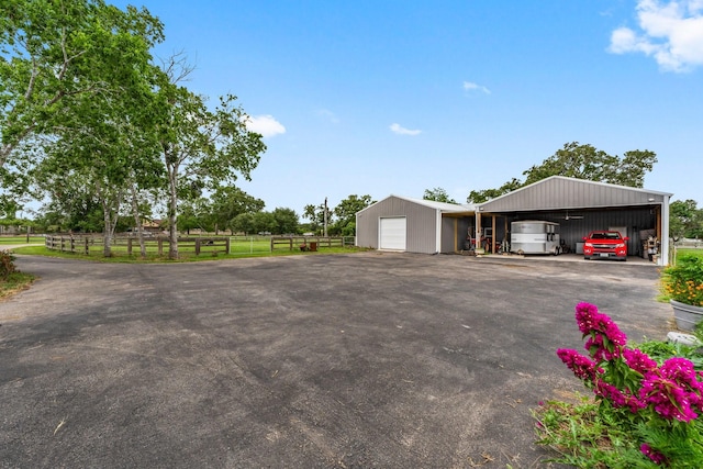 43 Windmill Dr, Hempstead, TX 77445 - view of home's exterior with a detached garage and an outbuilding