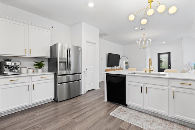 6213 Arcadia Sound Ln, Houston, TX 77365 - kitchen with stainless steel fridge with ice dispenser, black dishwasher, a chandelier, white cabinets, and light countertops