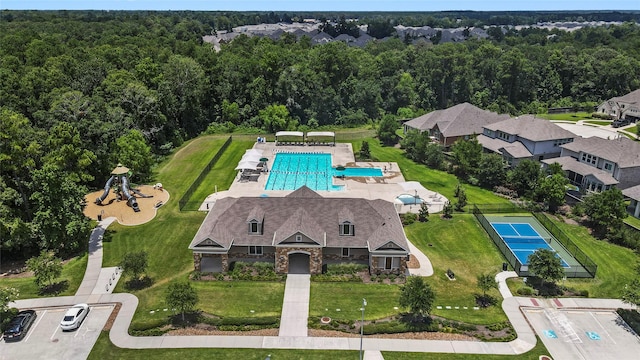 6213 Arcadia Sound Ln, Houston, TX 77365 - drone / aerial view of a pool area and a heavily wooded area