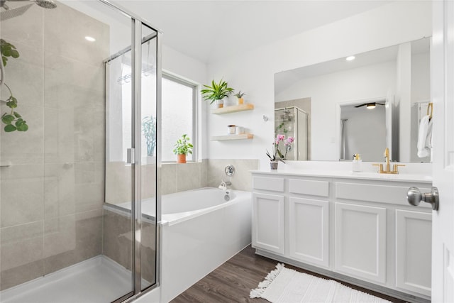 6213 Arcadia Sound Ln, Houston, TX 77365 - full bathroom with a stall shower, a bath, double vanity, and wood finished floors