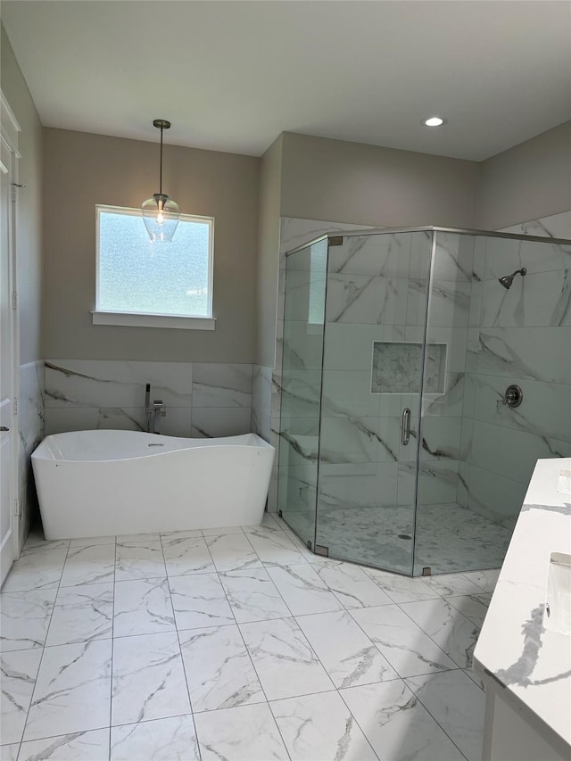 13978 Jamaica Cir, Willis, TX 77318 - full bathroom featuring a freestanding bath, vanity, a marble finish shower, marble look tile flooring, and tile walls