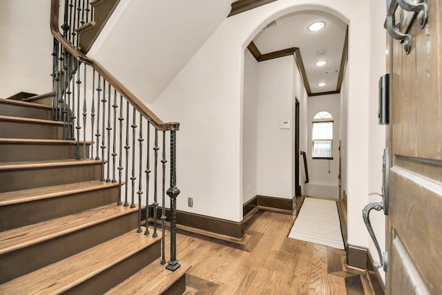 1241 W 24th St Unit B, Houston, TX 77008 - foyer with wood finished floors, arched walkways, ornamental molding, and stairs