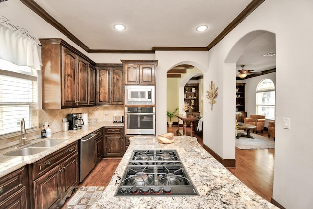 1241 W 24th St Unit B, Houston, TX 77008 - kitchen featuring appliances with stainless steel finishes, arched walkways, wood finished floors, crown molding, and ceiling fan