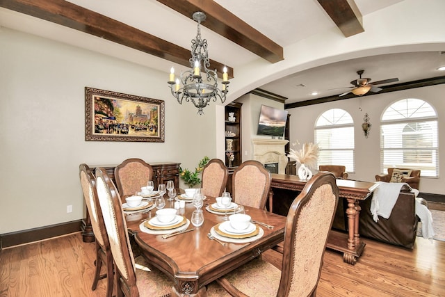 1241 W 24th St Unit B, Houston, TX 77008 - dining room featuring light wood-style flooring, a ceiling fan, a fireplace, a chandelier, and beam ceiling