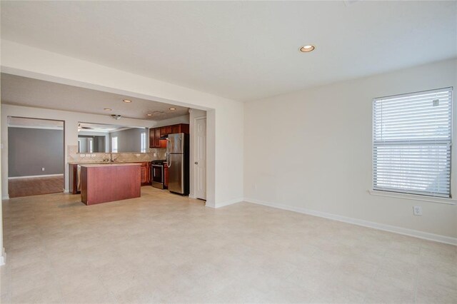 2666 Skyview Knoll Ct, Houston, TX 77047 - kitchen featuring appliances with stainless steel finishes, open floor plan, recessed lighting, light countertops, and decorative backsplash