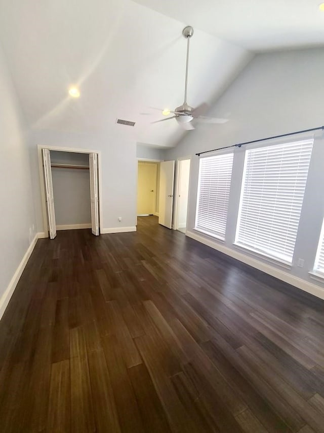 7447 Cambridge St Unit 8, Houston, TX 77054 - unfurnished bedroom featuring dark wood-style floors, a closet, ceiling fan, multiple windows, and high vaulted ceiling