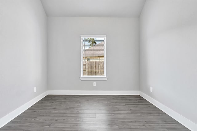10329 S Goshawk Trl, Conroe, TX 77385 - empty room featuring baseboards and wood finished floors