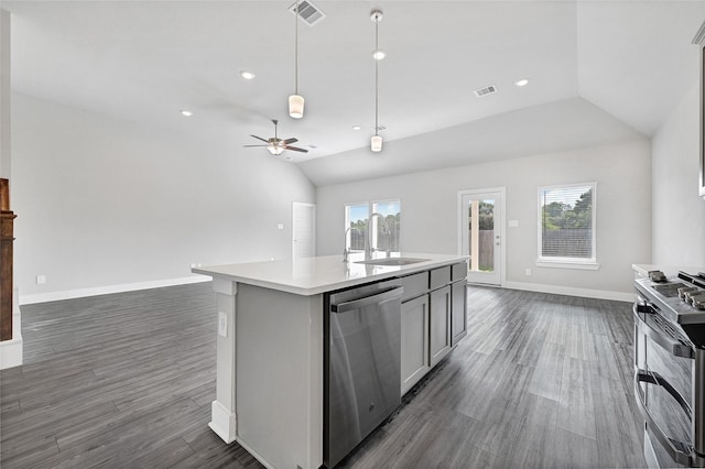10329 S Goshawk Trl, Conroe, TX 77385 - kitchen with stainless steel appliances, open floor plan, vaulted ceiling, dark wood-style flooring, and recessed lighting