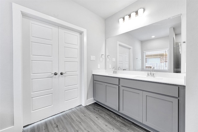 10329 S Goshawk Trl, Conroe, TX 77385 - full bath featuring wood finished floors and double vanity