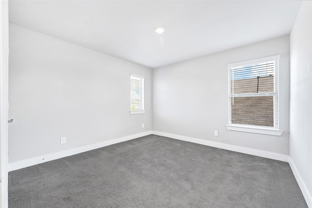 10329 S Goshawk Trl, Conroe, TX 77385 - empty room featuring dark carpet and plenty of natural light