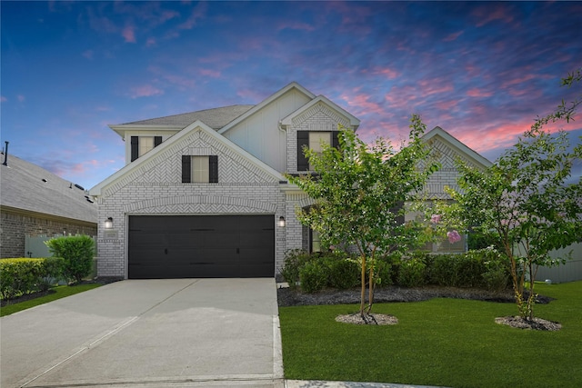 10329 S Goshawk Trl, Conroe, TX 77385 - view of front of property with driveway, a front lawn, and brick siding