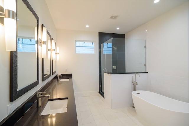 1037 Rutland St, Houston, TX 77008 - bathroom featuring a shower stall, a soaking tub, double vanity, recessed lighting, and tile patterned flooring